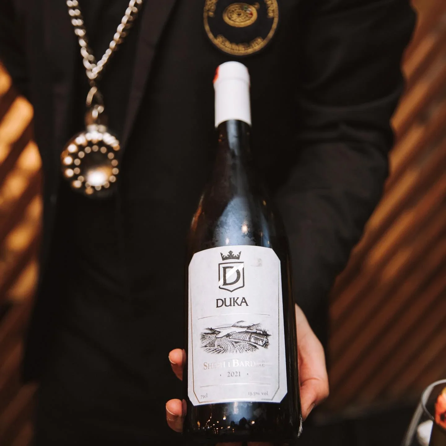 Sommelier holding Albanian White Wine Shesh i Bardhe from Duka Winery 