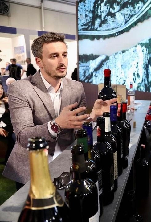 Caco winery ambassador introducing albanian wine labels at the wine festival 